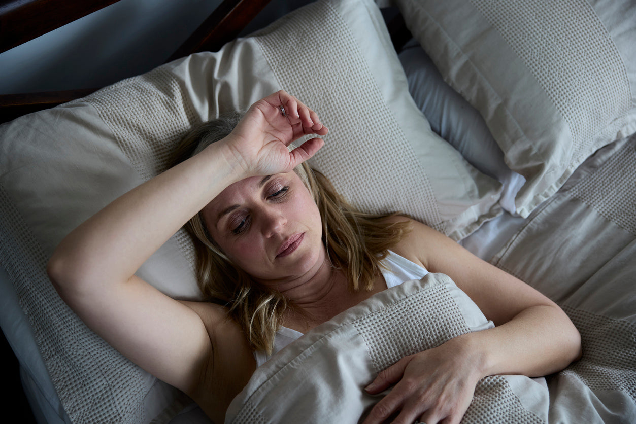 Woman struggling with overheating and poor sleep quality