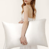 Woman holding a Jasmisilk 100% mulberry silk envelope pillowcase in ivory