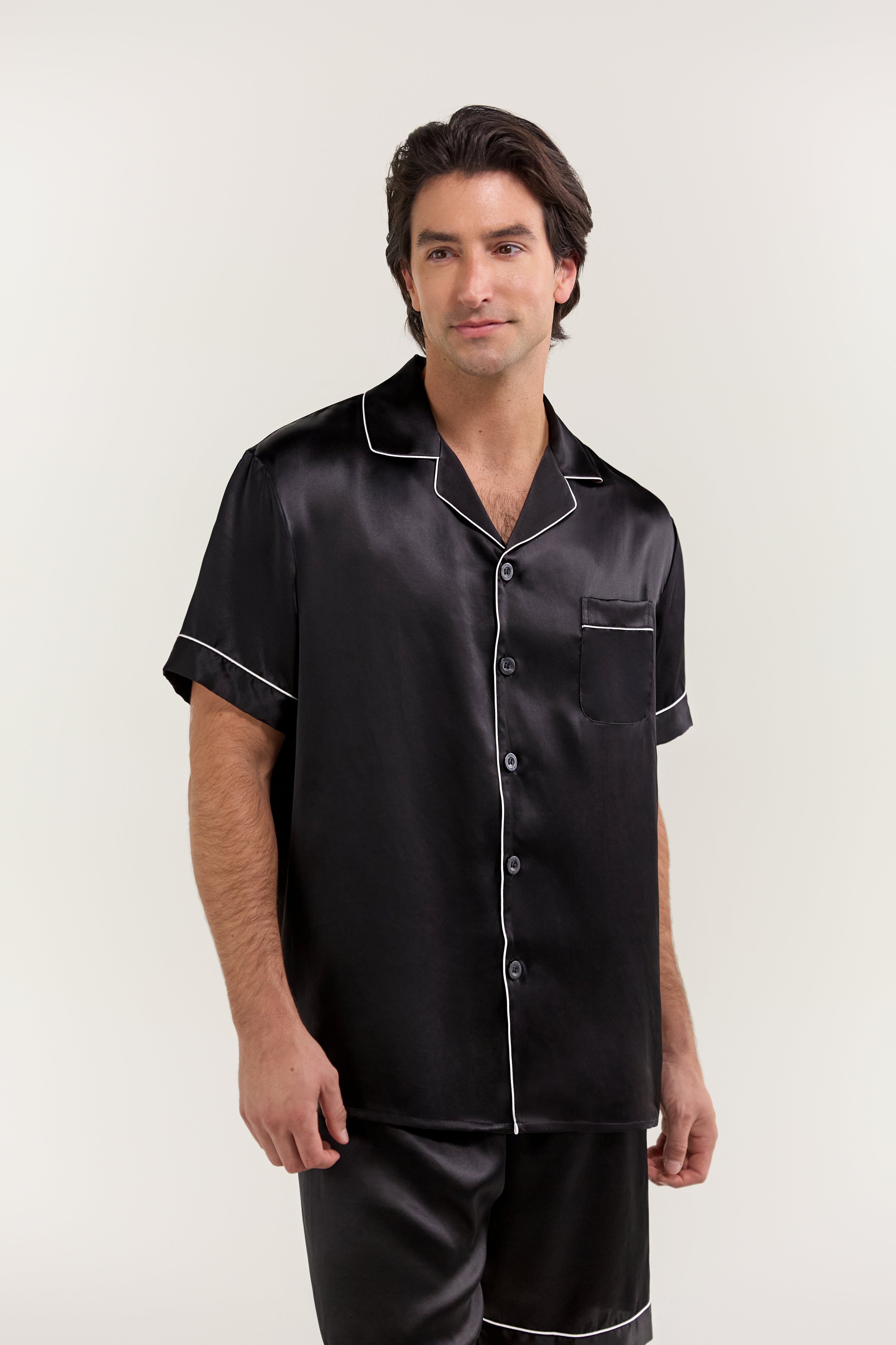 Close-up of man wearing Jasmisilk men's black short sleeve silk pajama