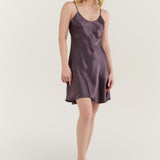 Woman wearing Jasmisilk pure silk spaghetti strap nightgown slip dress in quartz purple
