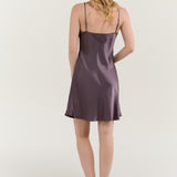 Back view of woman wearing Jasmisilk quartz purple pure silk spaghetti strap nightgown slip dress