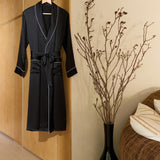 Jasmisilk men's black pure silk robe with white piping hanging on wooden hanger