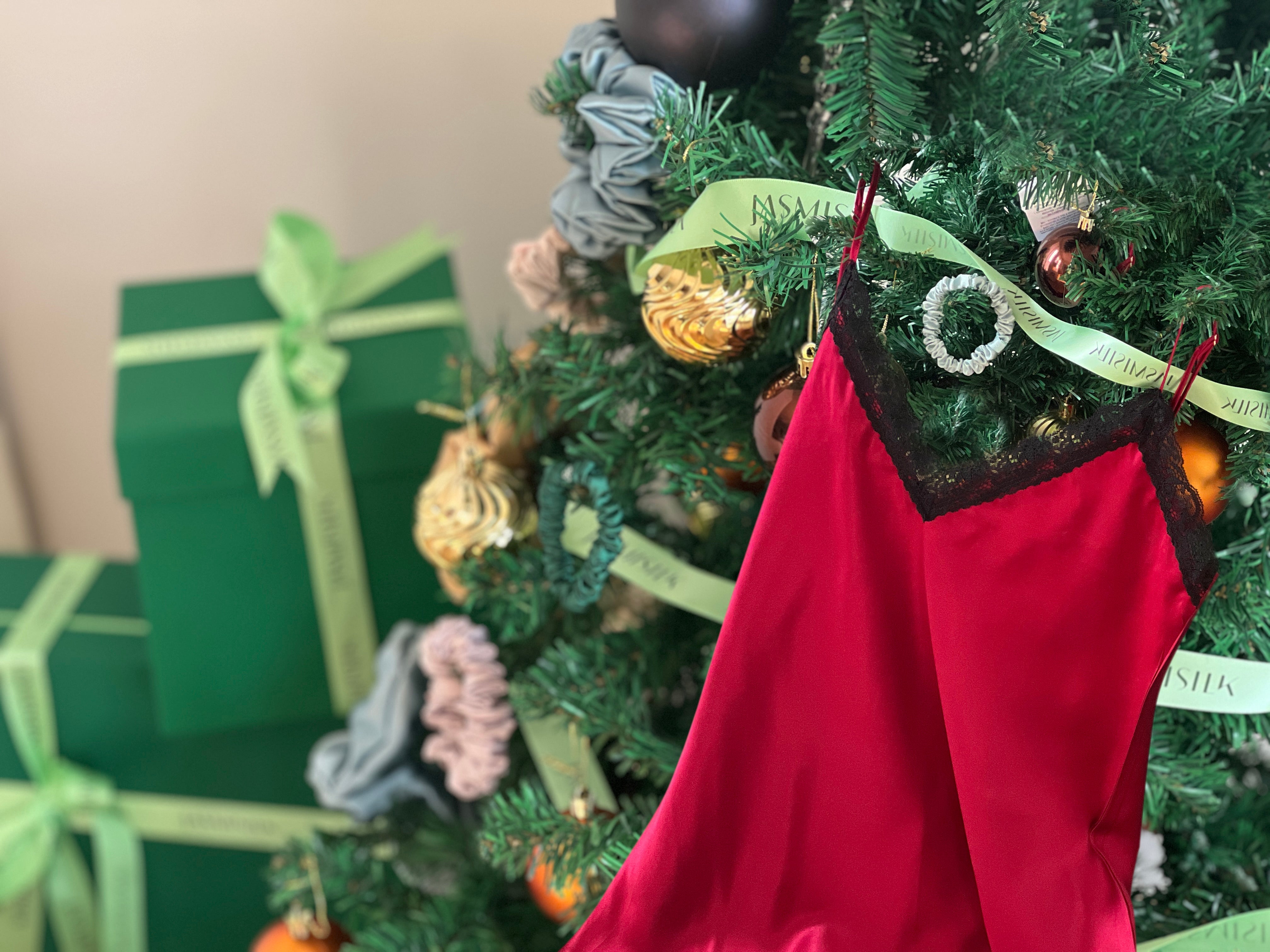 Holiday gifts and red Silk Nightgowns for Women under a Christmas tree by Jasmisilk
