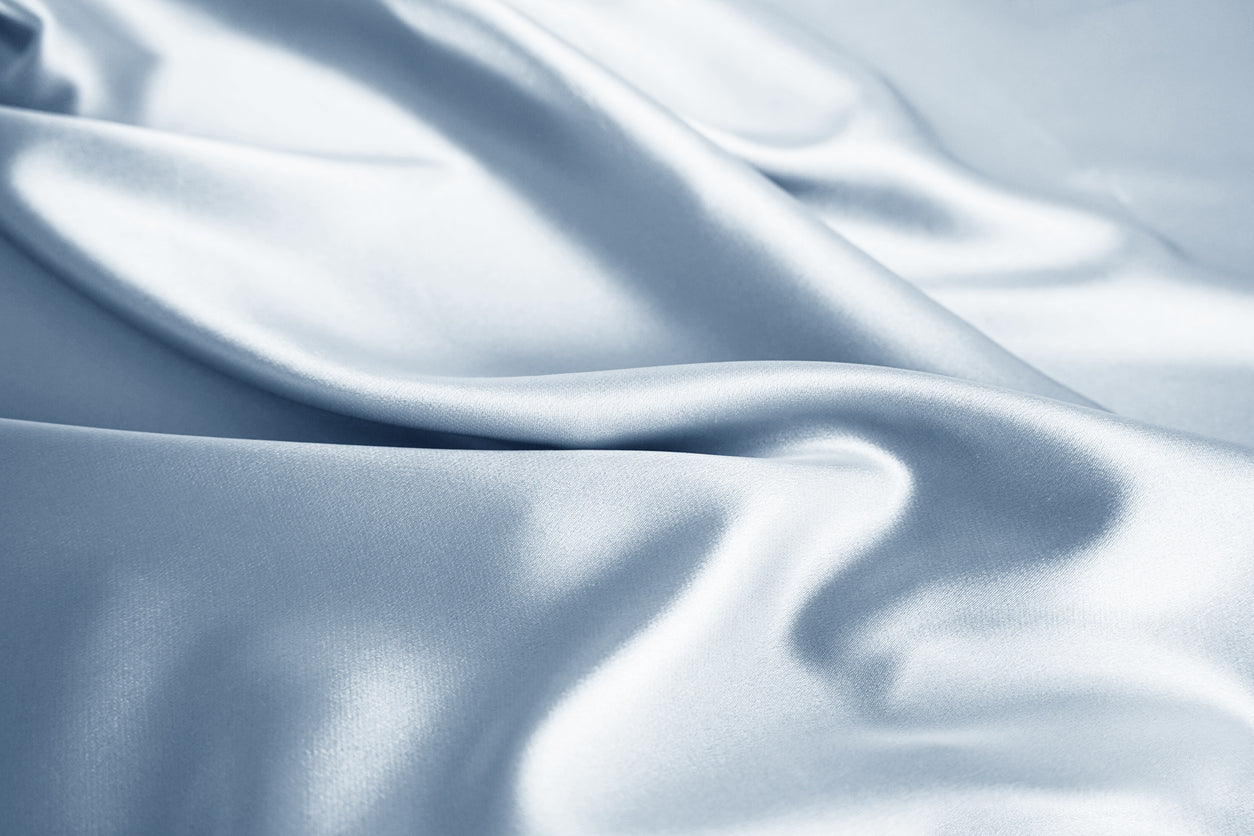 Close-up of mulberry silk fabric showing smooth texture, fine weave, and natural luster