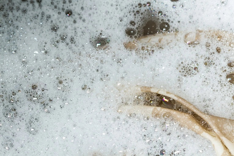 Silk pillowcase soaking in bubbly water during wash