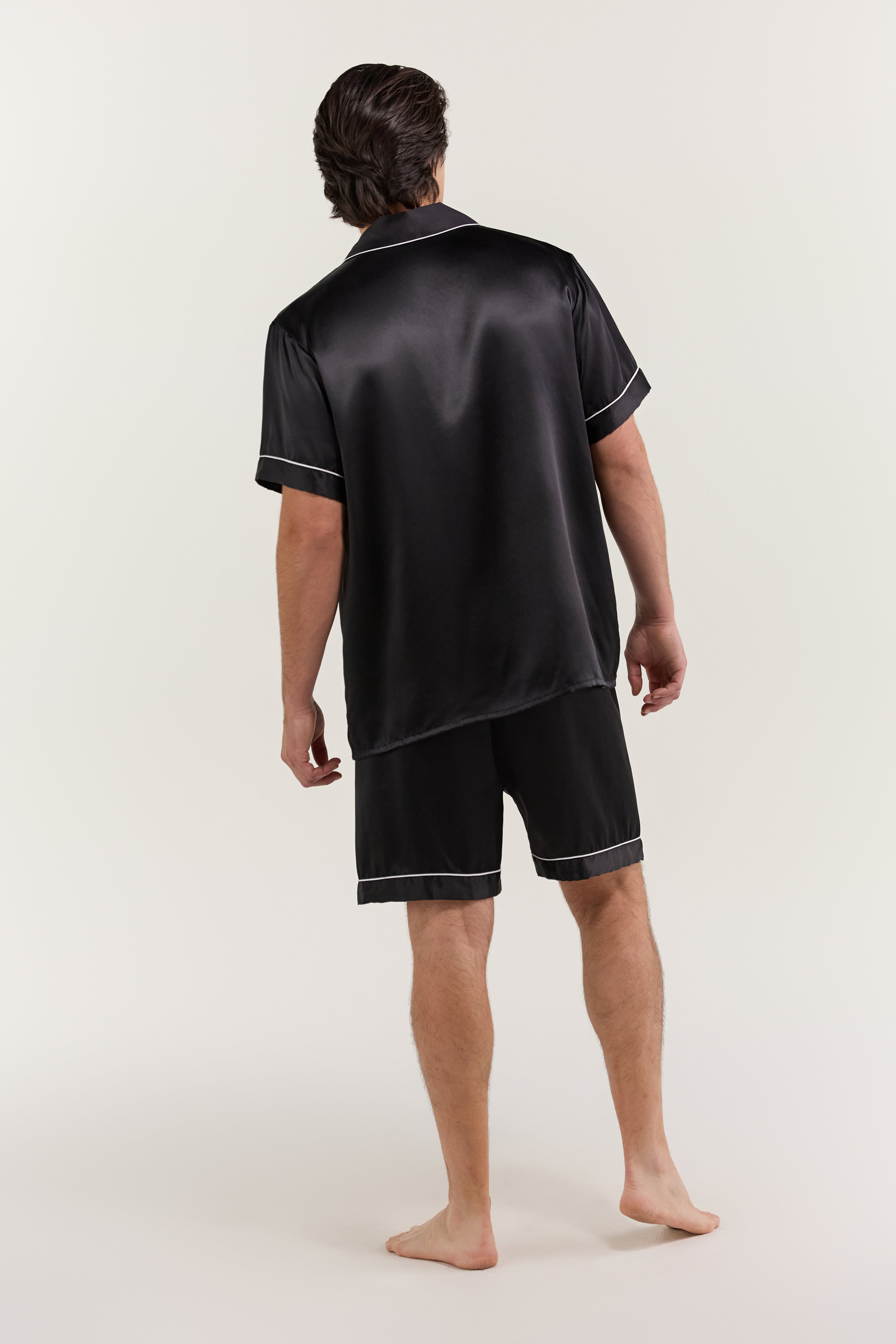Back view of man wearing Jasmisilk men's classic black short sleeve silk pajama set
